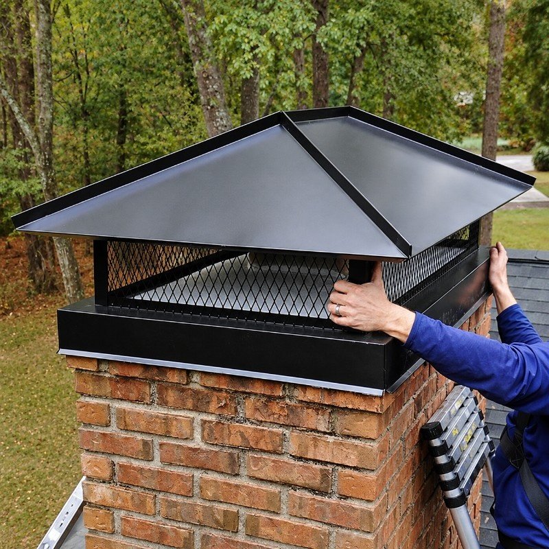Stainless steel chimney cap and repaired crown on a residential chimney in Manhasset Hills