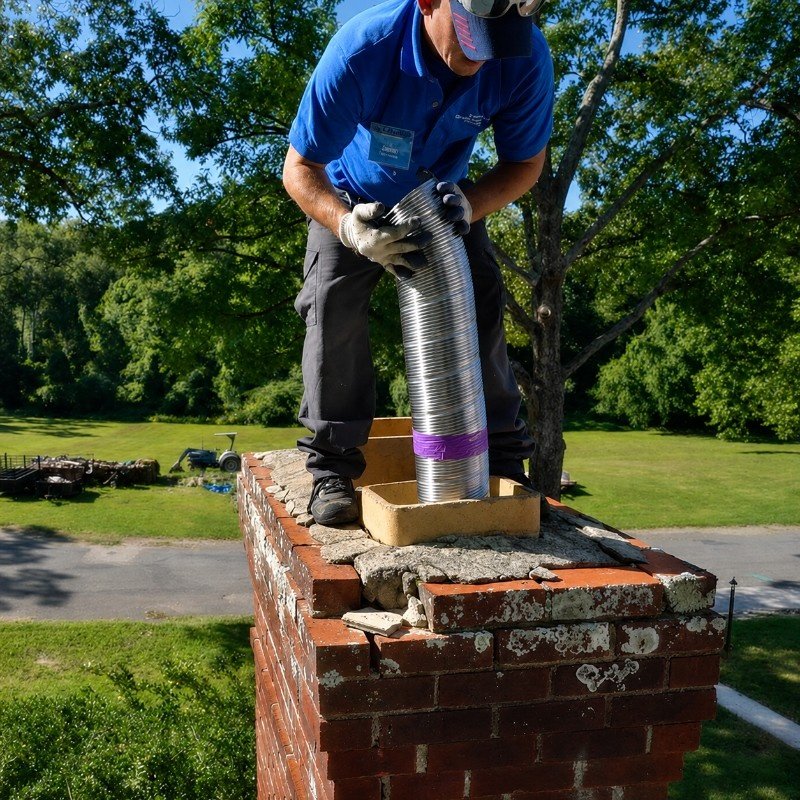 Cracked clay tile chimney liner found during inspection in an older Manhasset Hills home